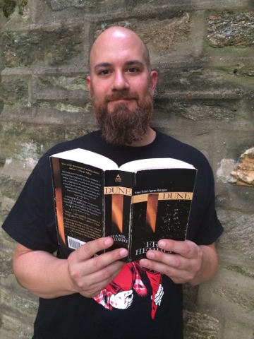 Gary childs holds a copy of The Dune Series